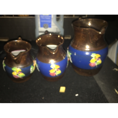 100E - Set of Three graduated Lustre Ware Jugs With Scenes and Birds