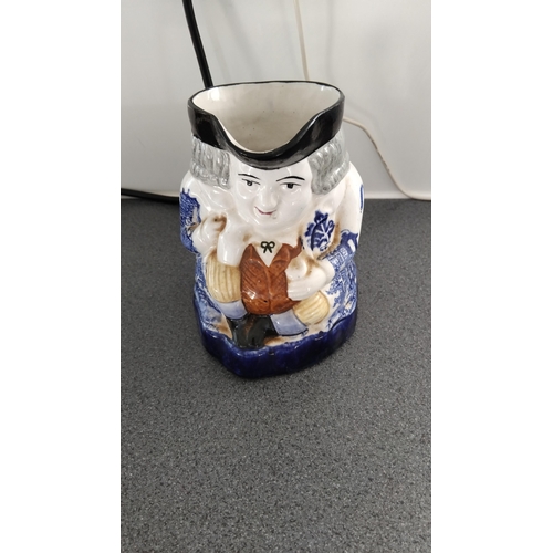 446 - BLUE AND WHITE WILLOW PATTERN TOBY JUG