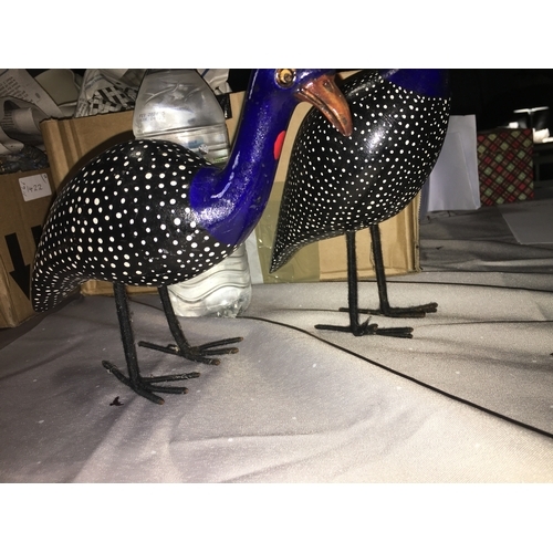 579 - PAIR OF WOODEN BIRDS ON METAL FEET