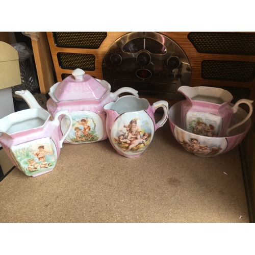 292 - LOVELY SELECTION OF PINK AND WHITE CHERUB DESIGNED JUGS BOWL AND TEA POT Slight nick to spout