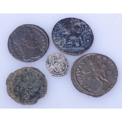 110 - A small silver coin and 4 Roman bronze coins