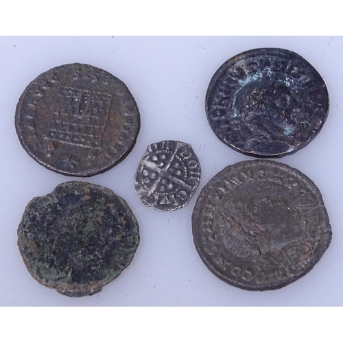 110 - A small silver coin and 4 Roman bronze coins