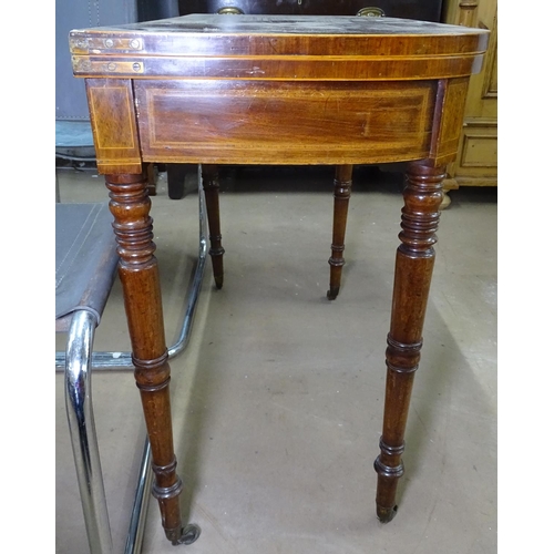 1128 - A 19th century cross-banded mahogany fold over card table, with boxwood stringing and banding, raise... 