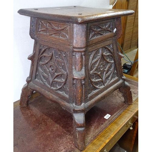 1130 - An Antique carved oak stool, with panelled sides on shaped feet, W48cm, H53cm