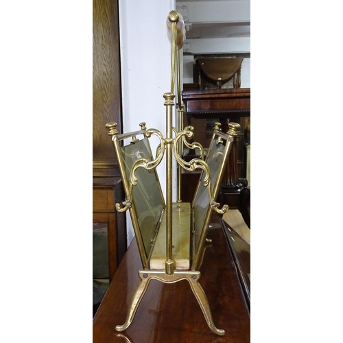 1138 - A gilt-brass magazine rack with onyx handle and smoked glass sides