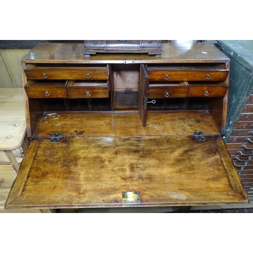 1143 - A 19th century mahogany bureau with a drawer fitted interior, 4 graduated long drawers on bracket fe... 