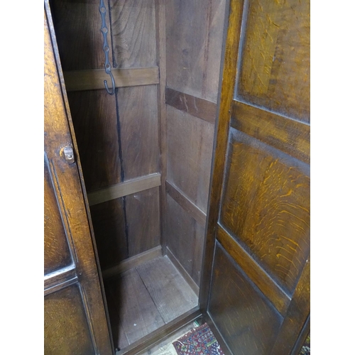 1150 - An Ipswich oak design hall cupboard, with 2 carved panelled doors, W110cm