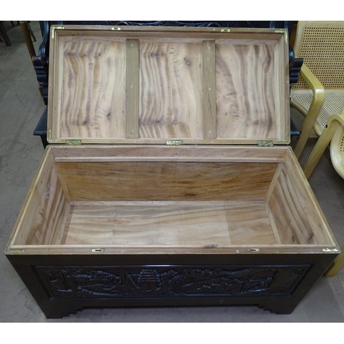 1172 - An Oriental carved camphor wood blanket chest, W101cm