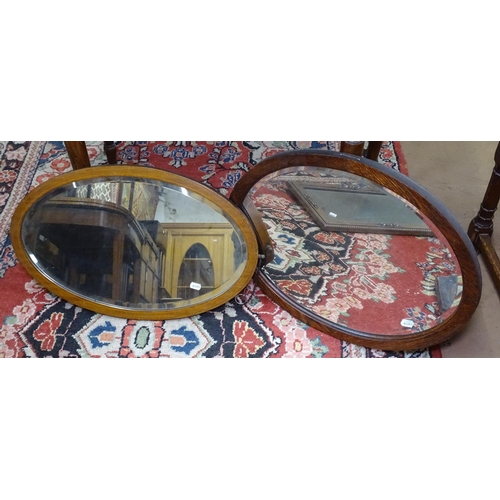 1183 - 3 1920s oak wall mirrors, and a mahogany oval wall mirror (4)