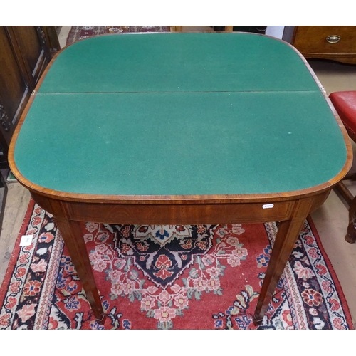 1186 - A 19th century mahogany fold over card table, with banded decoration, raised on square tapered legs ... 