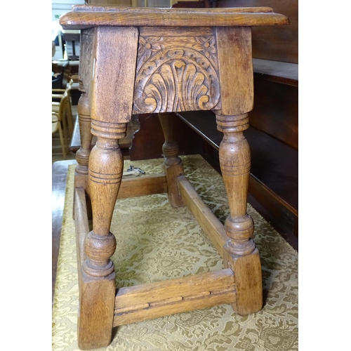 1191 - A carved oak joint stool, W56cm