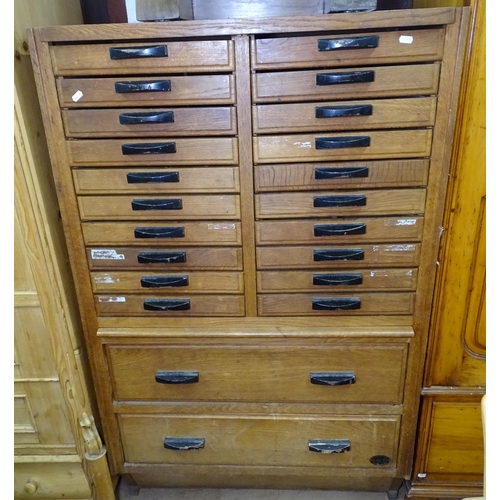 1199 - A Vintage Continental oak haberdashery cabinet, with 20 short drawers and 2 long drawers under, bear... 