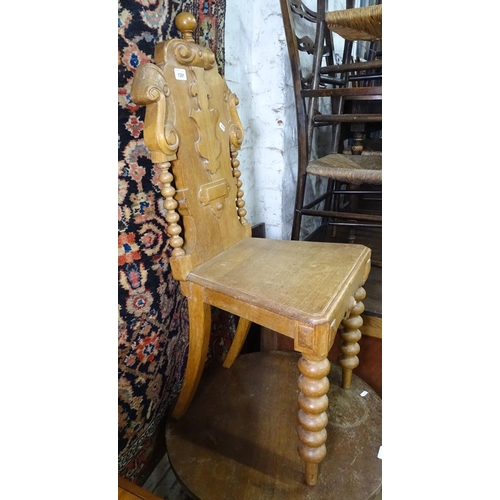 1291 - A Victorian carved oak shield-back hall chair