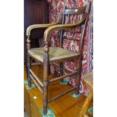 1295 - A 19th century rush-seated elm elbow-chair