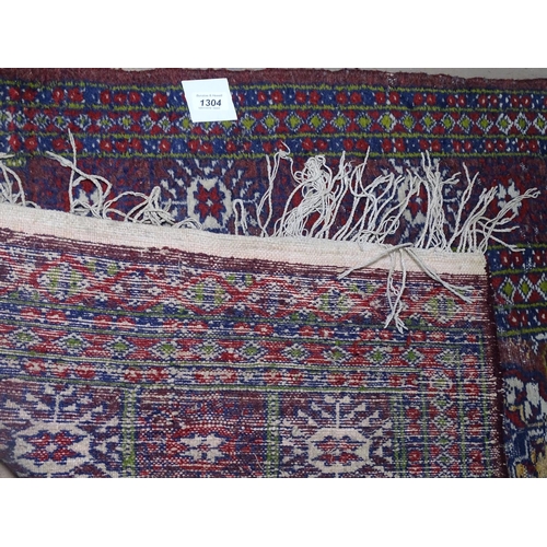 1304 - A red ground Baluchi rug, 160cm x 90cm