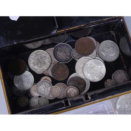 132 - A cash tin containing various coins, including silver