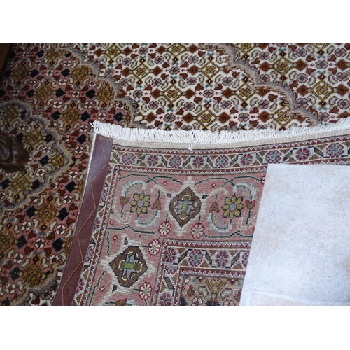 1320 - A peach ground Persian design wool rug, 200cm x 150cm