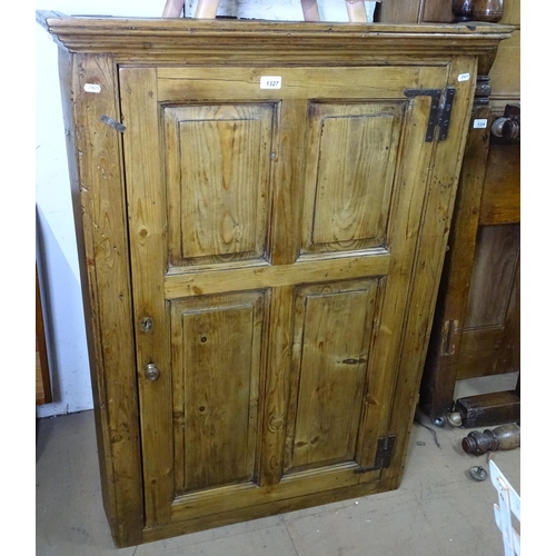 1327 - An early 19th century polished pine hanging corner cabinet, with single panelled door, W84cm