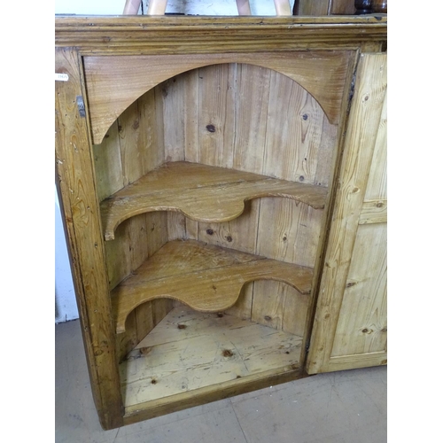 1327 - An early 19th century polished pine hanging corner cabinet, with single panelled door, W84cm