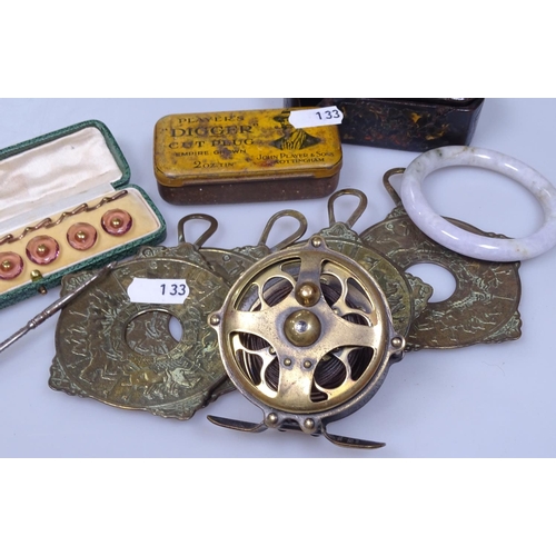 133 - A tobacco tin, a jade bangle, cased studs, horse racing brasses etc