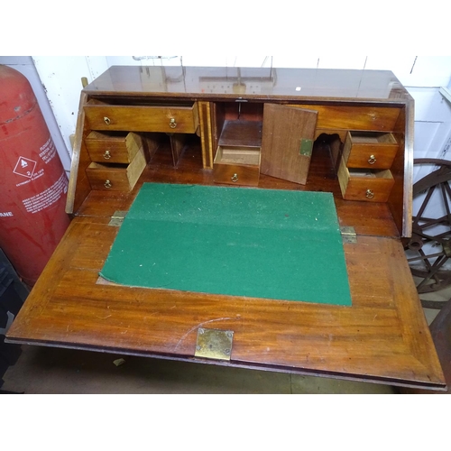 1335 - A George III mahogany bureau, fall front revealing a satinwood-banded fitted interior, with 4 long g... 