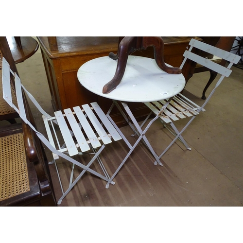 1339 - A painted metal folding garden bistro table, and 2 matching folding chairs