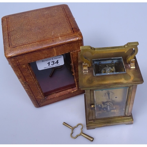 134 - A brass carriage clock in leather case, with glass panel, height 5.5