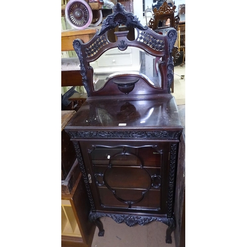 1343 - A Victorian mahogany side cabinet, with a raised carved and pierced mirror back, a glazed door under... 