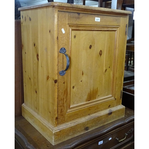 1377 - A small polished pine cabinet, with panelled door, W61cm