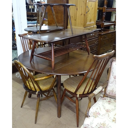 1379 - A dark elm Ercol drop leaf kitchen table, together with a pair of Ercol arch-top elbow chairs, and a... 