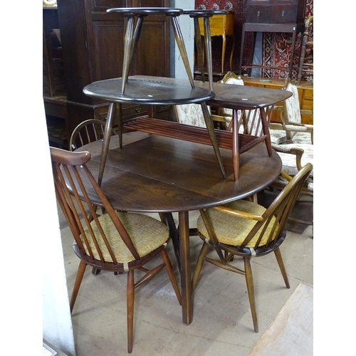 1379 - A dark elm Ercol drop leaf kitchen table, together with a pair of Ercol arch-top elbow chairs, and a... 