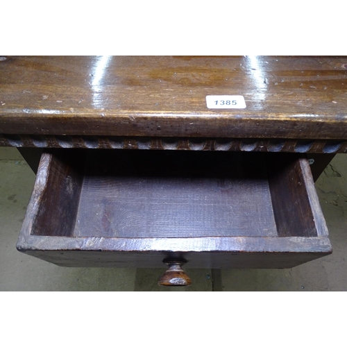 1385 - An oak rectangular lamp table, with single drawer, and on baluster legs, W69cm, H58cm