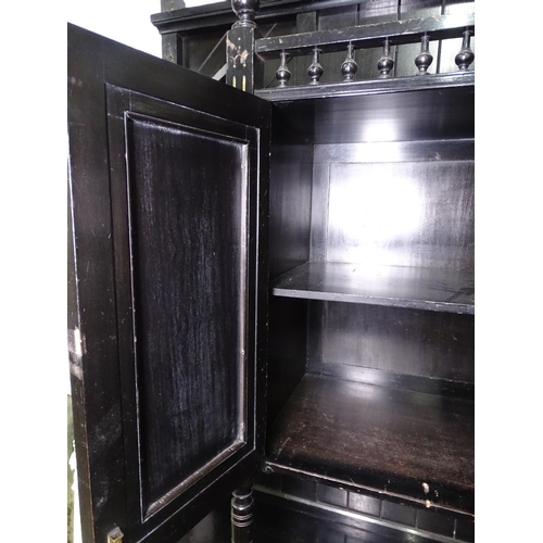 1394 - An Edwardian ebonised 2-section cabinet, the top having open shelves and painted panel cupboard door... 