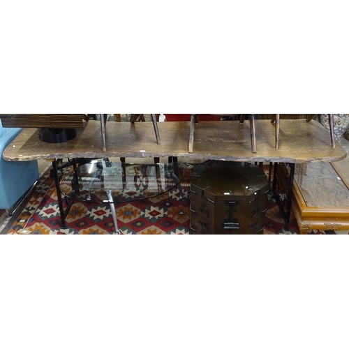 1415 - A large rustic rough-cut pine top dining table, on scrolled metal base, L258cm