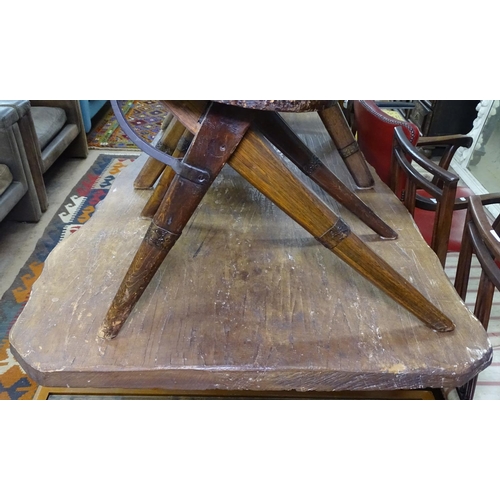 1415 - A large rustic rough-cut pine top dining table, on scrolled metal base, L258cm