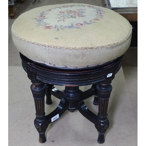 1442 - A Victorian ebonised and gilded revolving piano stool