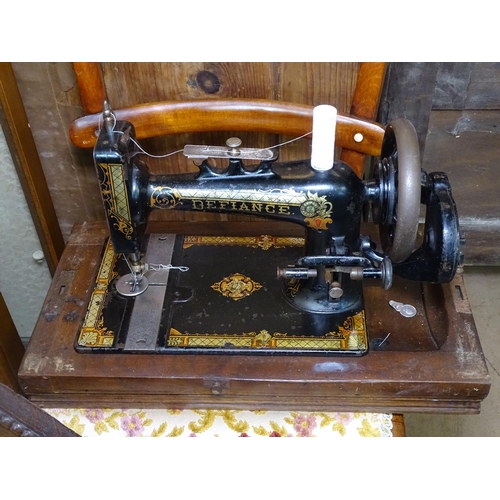 1455 - A 1930s walnut display cabinet, an oak-framed wall mirror, a sewing machine and a pair of hall chair... 