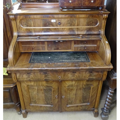 1459 - A 19th century Biedermeier desk in figured mahogany fitted with a tambour front, with drawer and cup... 