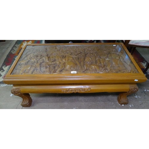 1469 - A rectangular hardwood coffee table, with a 3D carved top, raised on carved legs, W100cm