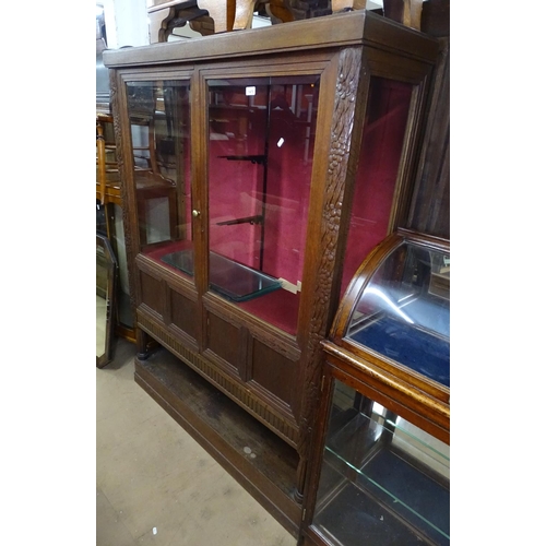 1470 - An early 20th century Continental oak display cabinet, with 2 beveled glazed and panelled doors, and... 