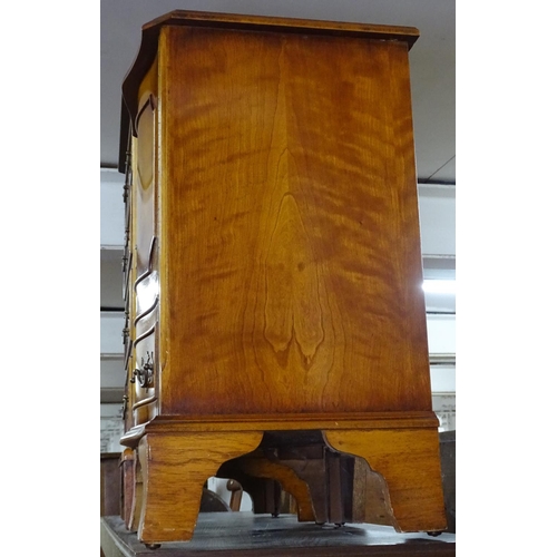 1472 - A reproduction cross-banded yew wood chest of 4 short drawers, and a similar cabinet (2)