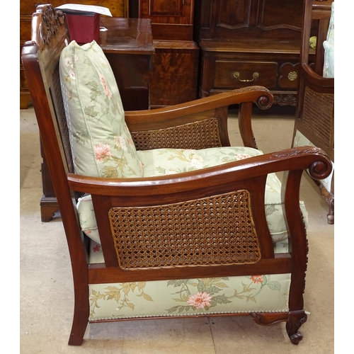 1481 - A pair of carved walnut-framed Bergere armchairs, with double cane panelled backs and arms