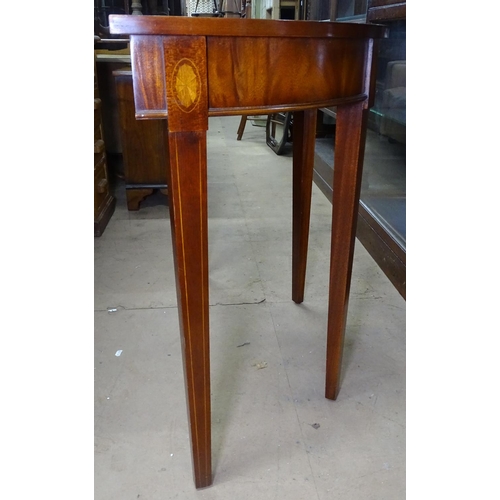 1483 - A reproduction mahogany demi lune console table, raised on tapered legs with marquetry inlaid decora... 