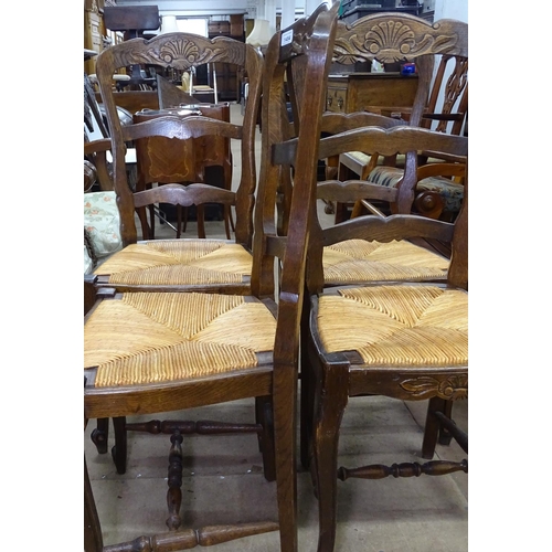 1484 - A set of 4 French oak ladder back chairs with rush seats.