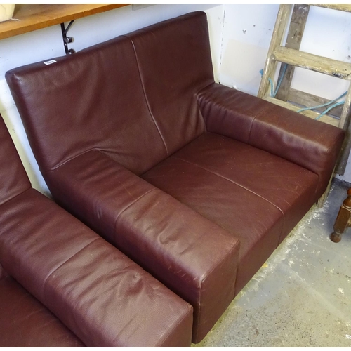 1508 - A burgundy leather club chair, on flat bar steel legs