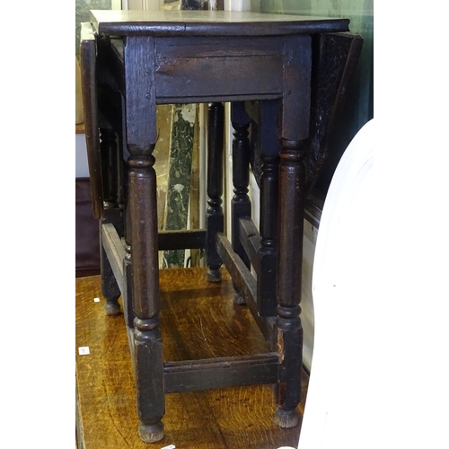 1510 - An 18th century oak oval gateleg table, on baluster legs, W97cm