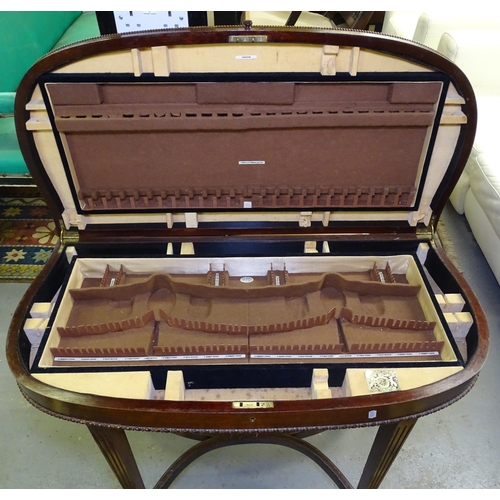 1530 - An Edwardian mahogany fold over cutlery table, raised on square tapered legs (no cutlery)