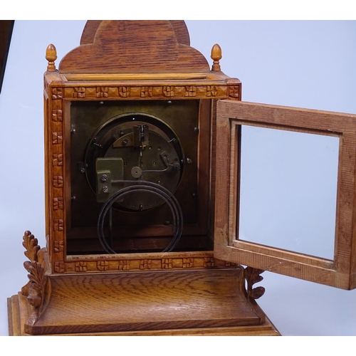 155 - An 8-day mantel clock in carved and glazed oak case, 16