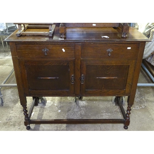 1580 - A 1930s oak sideboard with fitted drawers and cupboards, on barley twist legs, W107cm