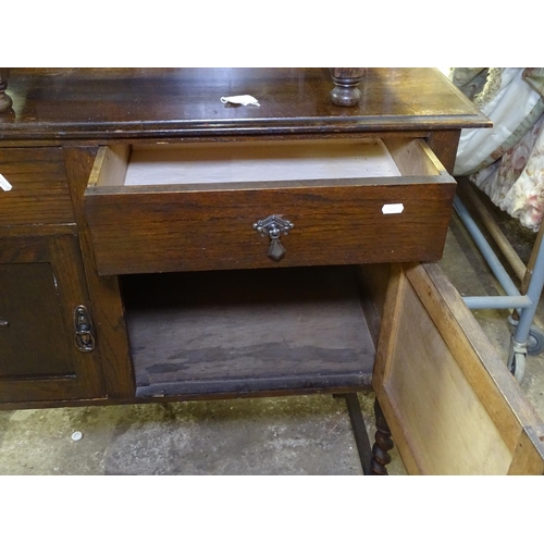 1580 - A 1930s oak sideboard with fitted drawers and cupboards, on barley twist legs, W107cm